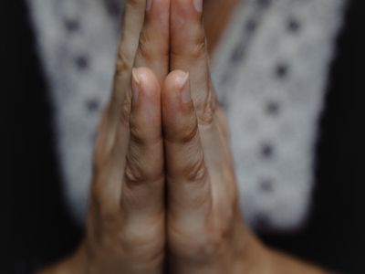 Close-up of hands in a meditative mudra gesture.